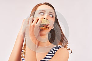 Girl quickly eats Burger, afraid of being caught