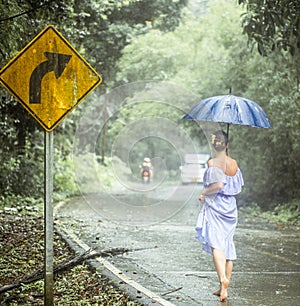 Girl in the rain along the road