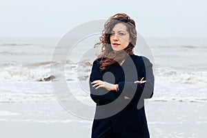 Girl rain sea wind winter portrait woman smile spring coat long hair curly mood shore snow beach