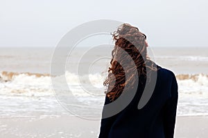 Girl rain sea wind winter portrait woman smile spring coat long hair curly mood shore snow beach