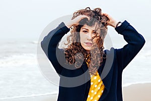 Girl rain sea wind winter portrait woman smile spring coat long hair curly mood shore snow beach