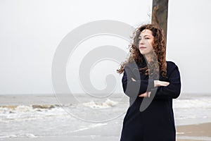 Girl rain sea wind winter portrait woman smile spring coat long hair curly mood shore snow beach autumn deadpan