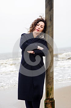 Girl rain sea wind winter portrait woman smile spring coat long hair curly mood shore snow beach autumn deadpan