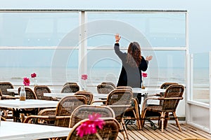 Girl rain sea wind winter portrait woman smile spring coat long hair curly mood shore snow beach cafe flower