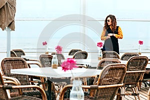 Girl rain sea wind winter portrait woman smile spring coat long hair curly mood shore snow beach cafe flower