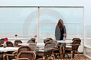 Girl rain sea wind winter portrait woman smile spring coat long hair curly mood shore snow beach cafe flower