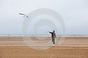 Girl rain sea wind winter portrait woman smile spring coat long hair curly mood shore snow beach kite