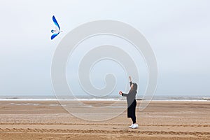 Girl rain sea wind winter portrait woman smile spring coat long hair curly mood shore snow beach kite