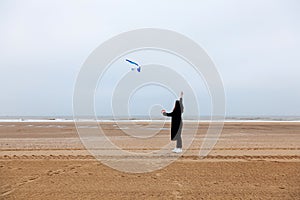 Girl rain sea wind winter portrait woman smile spring coat long hair curly mood shore snow beach kite