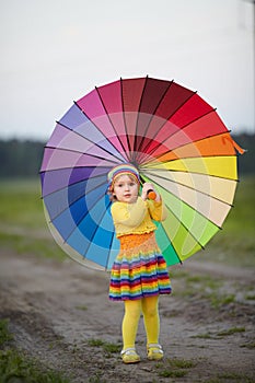 girl with rainbow umrella in the field