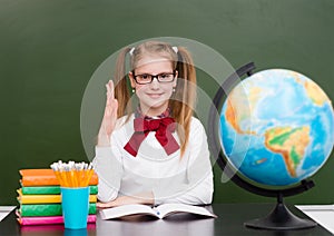 Girl raising hand knowing the answer to the question photo