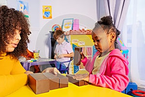 Girl range and sort blocks by size in nursery photo