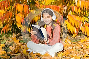 Girl read book on autumn day. Autumn literature concept. Child enjoy reading. Studying twice faster using visual and