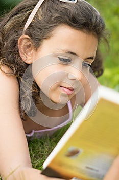 Girl reading a book in the garden