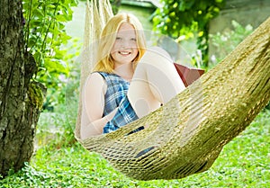 Girl reading book on hammock