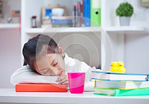 Girl reading a book at home. Girl studing at table on white room