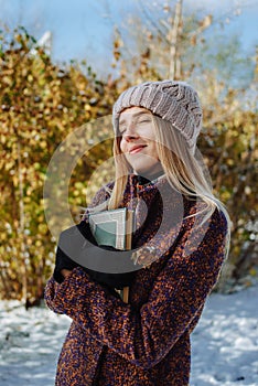 Girl reading book outdoors in winter