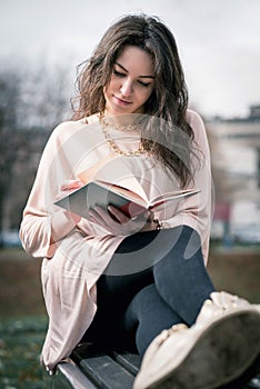 Girl reading a book in park