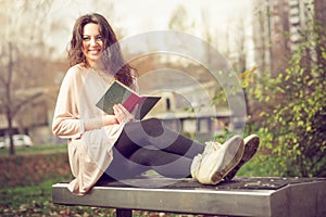 Girl reading a book in park