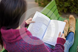 Girl reading a book in the park