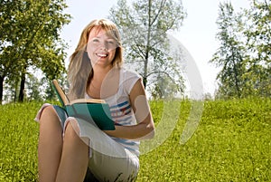 Girl reading a book in the park