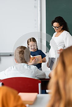 girl reading book while standing