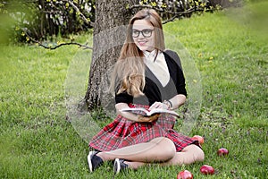 Girl reading book / student reading a book/ in park /