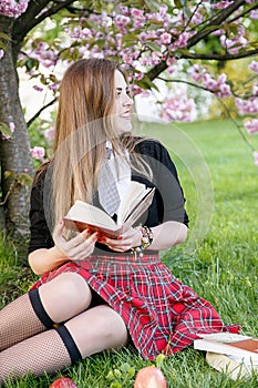 Girl reading book / student reading a book/ in park /