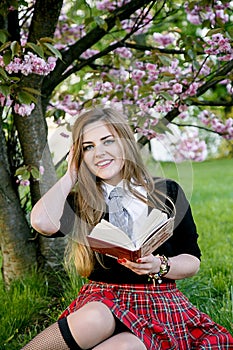 Girl reading book / student reading a book/ in park /