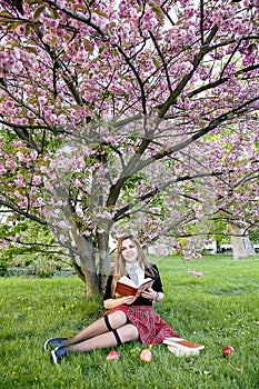 Girl reading book / student reading a book/ in park /