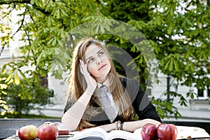 Girl reading book / student reading a book/ in park /