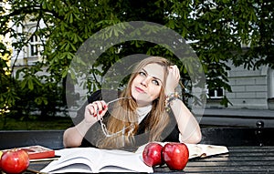 Girl reading book / student reading a book/ in park /