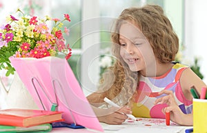 Girl reading book at the table