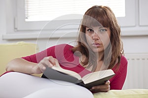 Girl reading a book opened photo