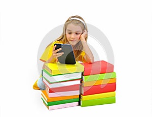 Girl reading e-book among books