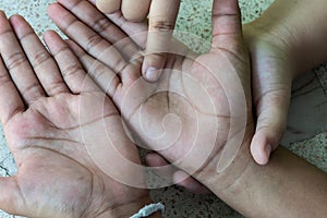 A girl reading a friend`s lines of the hand