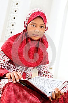 Girl Reading Koran photo