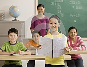 Girl reading report to classmates