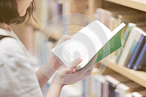 A girl reading some book in the bookstore