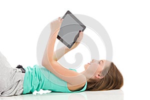 Girl reading something on a digital tablet