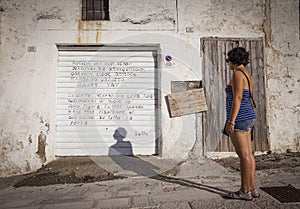 Girl reads poem written on rolling shutter