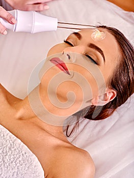 Girl receiving darsonval procedure at beauty salon
