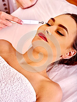 Girl receiving hydradermie procedure at beauty