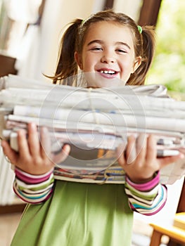 Girl recycling newspapers