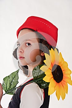 Girl in a red cap with a sunflower
