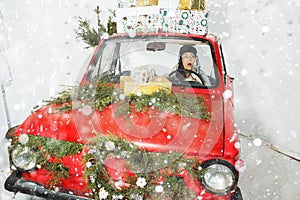 Girl in red car with Christmas gifts