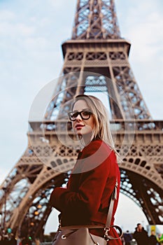 Girl in red coat and bag at parisian street