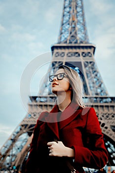 Girl in red coat and bag at parisian street