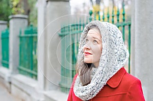 Girl with red coat and collar looking up