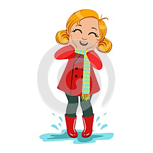 Girl In Red Coat And Rubber Boots, Kid In Autumn Clothes In Fall Season Enjoyingn Rain And Rainy Weather, Splashes And